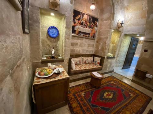 a living room with a plate of food on a table at Ürgüp Inn Cave Hotel in Urgup