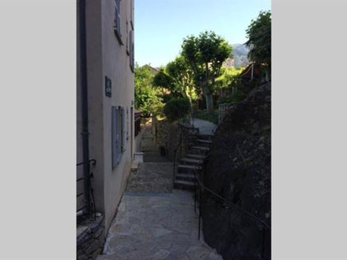 a stairway leading up to a building with a fence at Appartement Citadelle in Corte