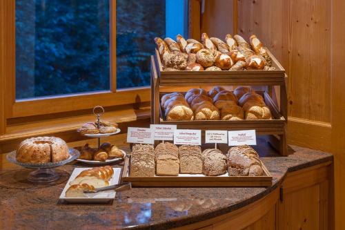 a bakery counter with various types of pastries and bread at Gasthof Löwen by Hotel Montafoner Hof in Schruns-Tschagguns