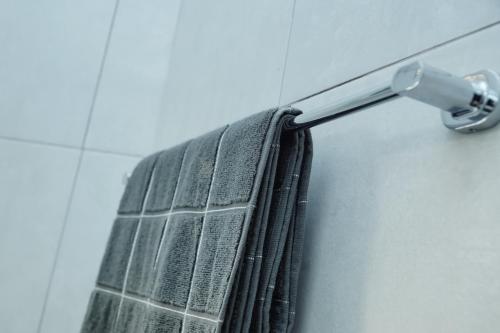 a towel hanging from a towel rack in a bathroom at Greyville Apartments in Lusaka