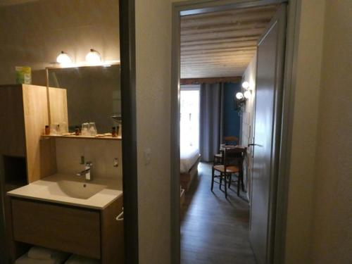 a bathroom with a sink and a toilet at Hôtel Du Midi in Thônes