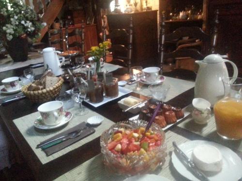 a table with a bowl of fruit on top of it at Moulin Rouhaud in Montboyer