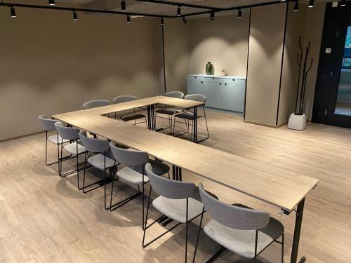 a conference room with wooden tables and chairs at Skyline Airport Hotel in Vantaa