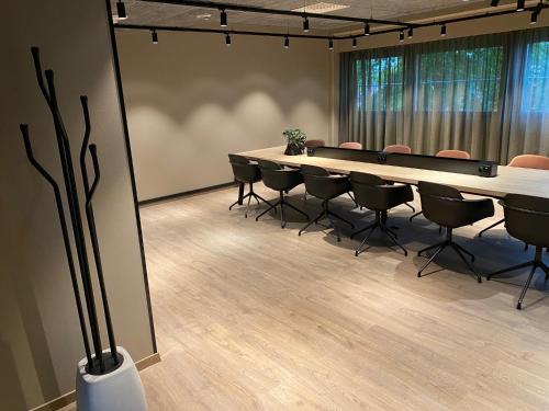 a conference room with a long table and chairs at Skyline Airport Hotel in Vantaa