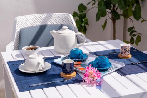 a table with a teapot and dishes on it at Dama Bianca Boutique Hotel Ostuni in Ostuni