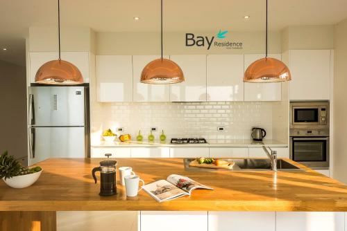 a kitchen with a wooden counter top and a sink at Bay Villas Koh Phangan in Salad Beach