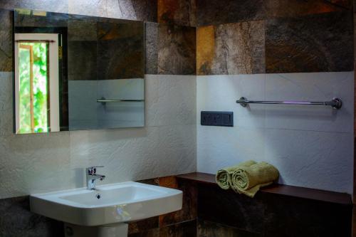 a bathroom with a sink and a mirror at Villa Fiori in Hikkaduwa