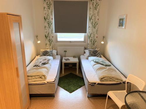 a small room with two beds and a window at Hällefors Vandrarhem-Hostel & Kanotcenter in Hällefors