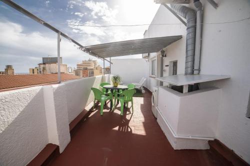 a balcony with a table and chairs on a building at Apartaments Atzavara in Calella