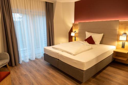 מיטה או מיטות בחדר ב-Hotel-Landgasthaus Ständenhof