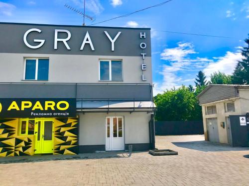 a building with a sign on the side of it at Gray Hotel in Vynohradiv