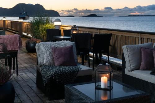 a patio with chairs and tables and a candle at Quality Hotel Ålesund in Ålesund