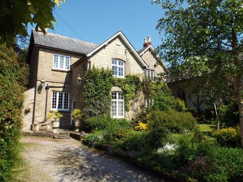 an old house with a garden in front of it at Old Vicarage B&B in Coleford
