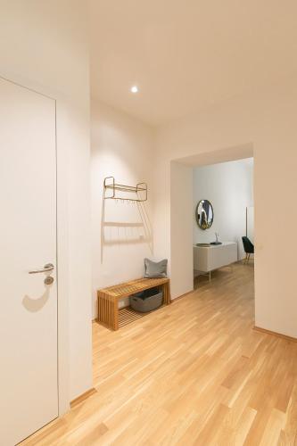 a living room with a wooden floor and a table at Mint@Naschmarkt Premium Apartments in Vienna