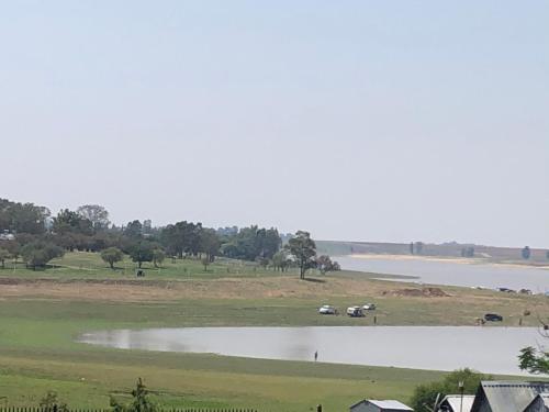a large body of water with a group of animals in a field at Best view family loft in Oranjeville