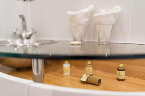 a bathroom with a glass counter top with a sink and a glass counter top at St Giles House in Norwich