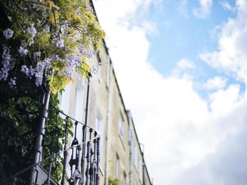 a building with purple flowers on the side of it at Percy Place Bath in Bath