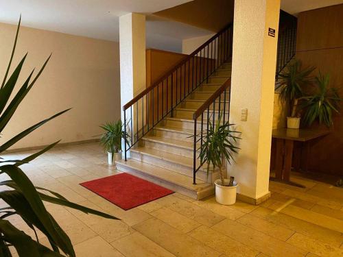 a staircase in a building with potted plants at Gasthof Kirchberger in Fürth