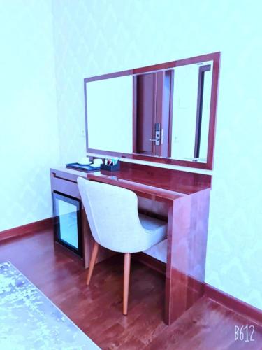 a desk with a white chair and a mirror at HOTEL AYNI in Dushanbe