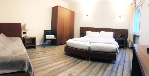 a bedroom with a bed and a wooden floor at Antica Trattoria in Cles