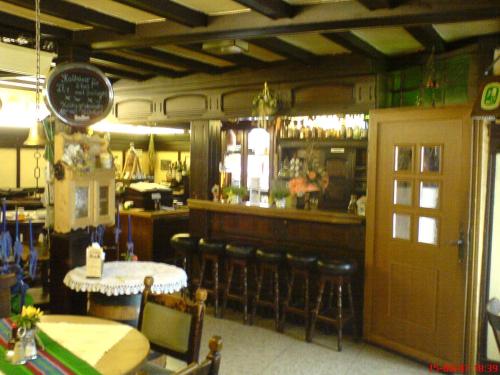 a restaurant with a bar with a table and chairs at Hotel Alt Wassenberg in Wassenberg