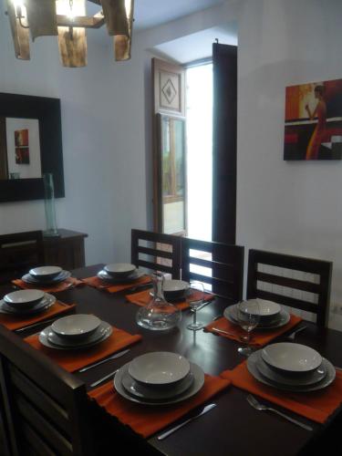 a dining room table with plates and glasses on it at Casa Montana in Bocairent