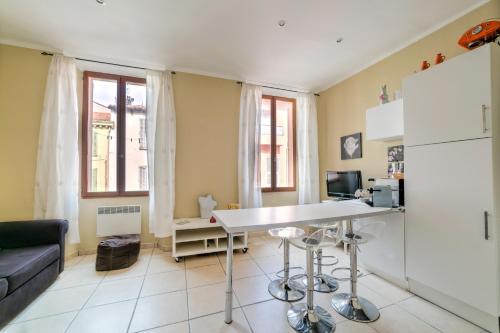 a kitchen with a couch and a table in a room at IMMOGROOM - Historic Area Le Suquet - 6min from the beaches in Cannes