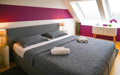 a bedroom with a large bed with two pillows on it at Hideaway Suite Danube Canal in Vienna