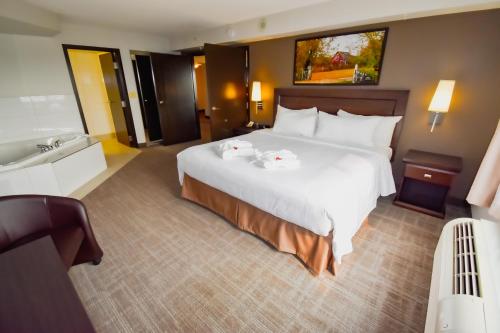 a hotel room with a large bed and a sink at Canad Inns Destination Centre Club Regent Casino Hotel in Winnipeg