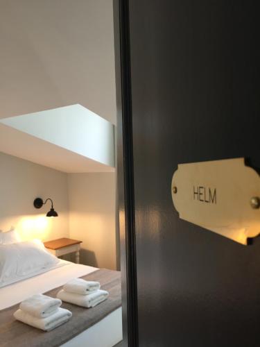 a bedroom with a bed with towels on it at Maison Caju - La Rochelle in La Rochelle