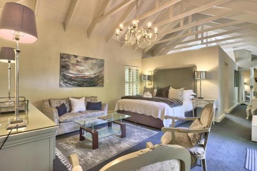 a bedroom with a bed and a couch at Fernwood Manor Boutique Guest House in Cape Town