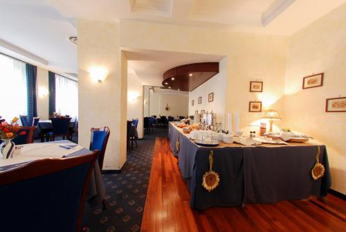 a dining room with two tables in a restaurant at Hotel Mediterraneo in Civitavecchia