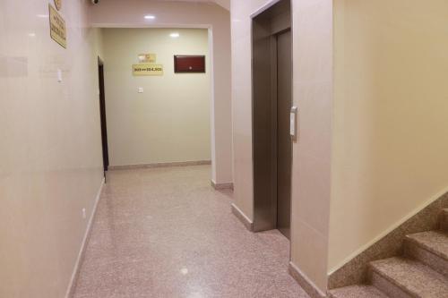 a hallway with stairs and a door in a building at Al Nile Hotel in Salalah