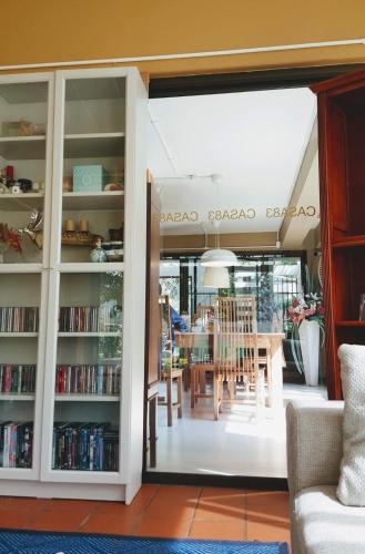 a glass door leading into a dining room with a table at Casa Khaoyai Bed&Breakfast in Mu Si