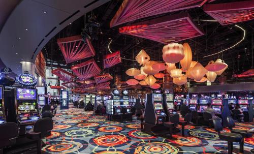 a casino with lots of slot machines and chandeliers at Ocean Casino Resort in Atlantic City