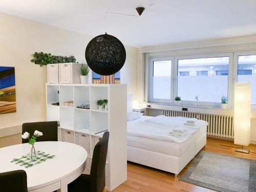 a bedroom with a bed and a table in a room at Relax Aachener Boardinghouse Appartements Premium 1 in Aachen