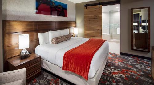 a hotel room with a large bed and a chair at Choctaw Casino Hotel - Grant in Grant