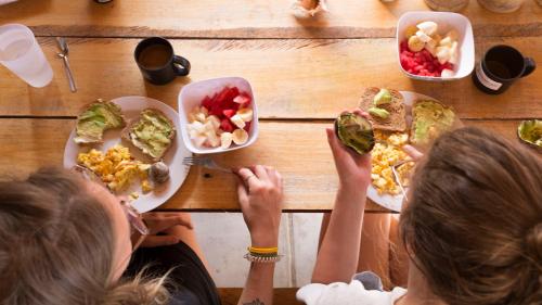 a group of people sitting at a table with plates of food at Free Spirit Ecuador, Puerto Engabao in Engabao
