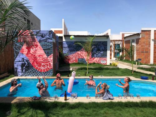 a group of people playing in a swimming pool at Free Spirit Ecuador, Puerto Engabao in Engabao