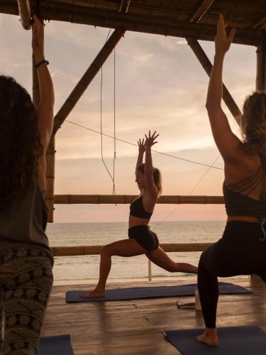 a group of people doing yoga on the beach at Free Spirit Ecuador, Puerto Engabao in Engabao