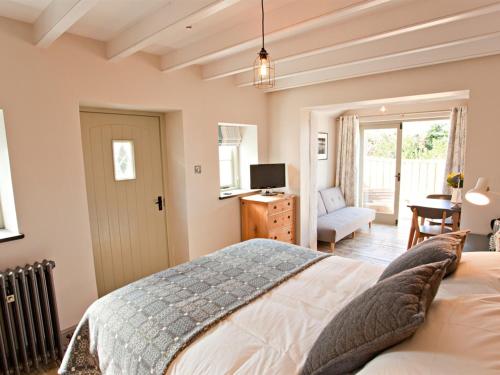 a bedroom with a large bed and a television at Grove Park in Newport Pembrokeshire