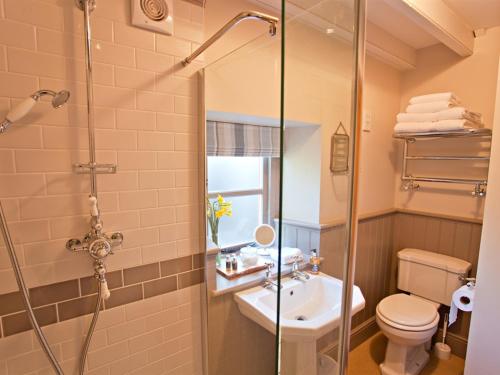a bathroom with a shower and a sink and a toilet at Grove Park in Newport
