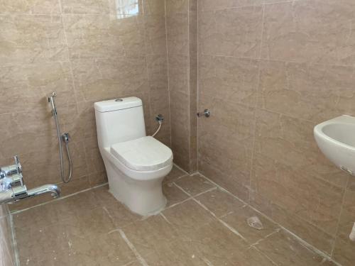 a bathroom with a toilet and a sink at SAGAR NIWAS-1BHK and 2BHK short stay flats - NH HCL EC Bommasandra in Bengaluru