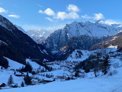 a small town in a snowy mountain valley at Ferienhaus Enzian in Prägraten am Großvenediger
