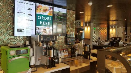 a coffee shop with a coffee machine on a counter at Wyndham Garden at Niagara Falls in Niagara Falls