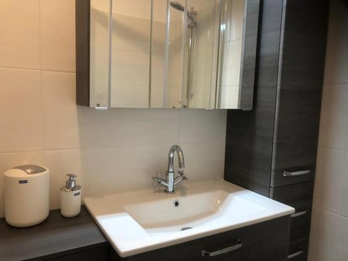 a bathroom with a sink and a cabinet at Familienurlaub am See in Bodensdorf