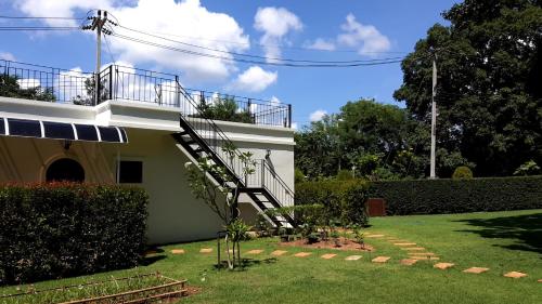 a house with a staircase in the yard at Casa Khaoyai Bed&Breakfast in Mu Si