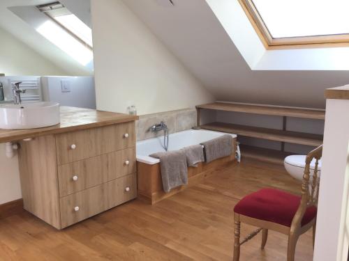 a bathroom with a sink and a bath tub at L'Orangerie "The Orangery" du parc des Nouies in Selles-sur-Cher