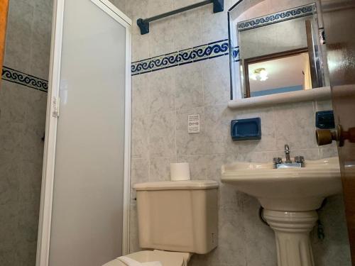 a bathroom with a toilet and a sink and a mirror at Hotel Francis Arlene Adults Only in Isla Mujeres