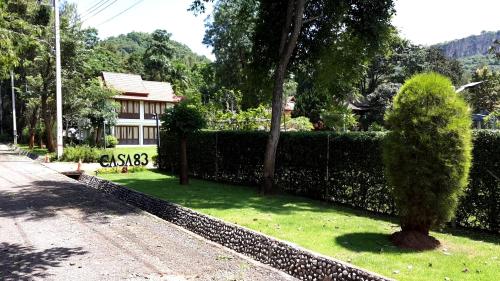 a hedge in front of a house with a bush at Casa Khaoyai Bed&Breakfast in Mu Si